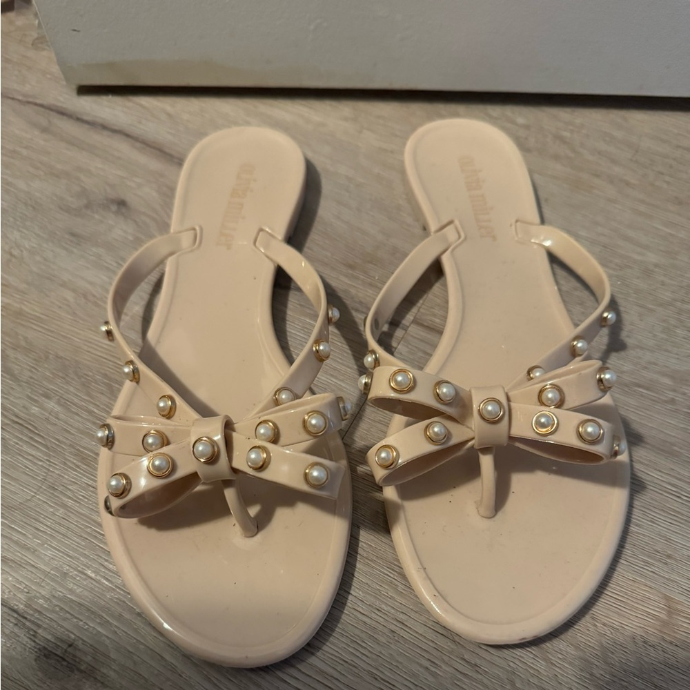 Tan and pearl flip flops